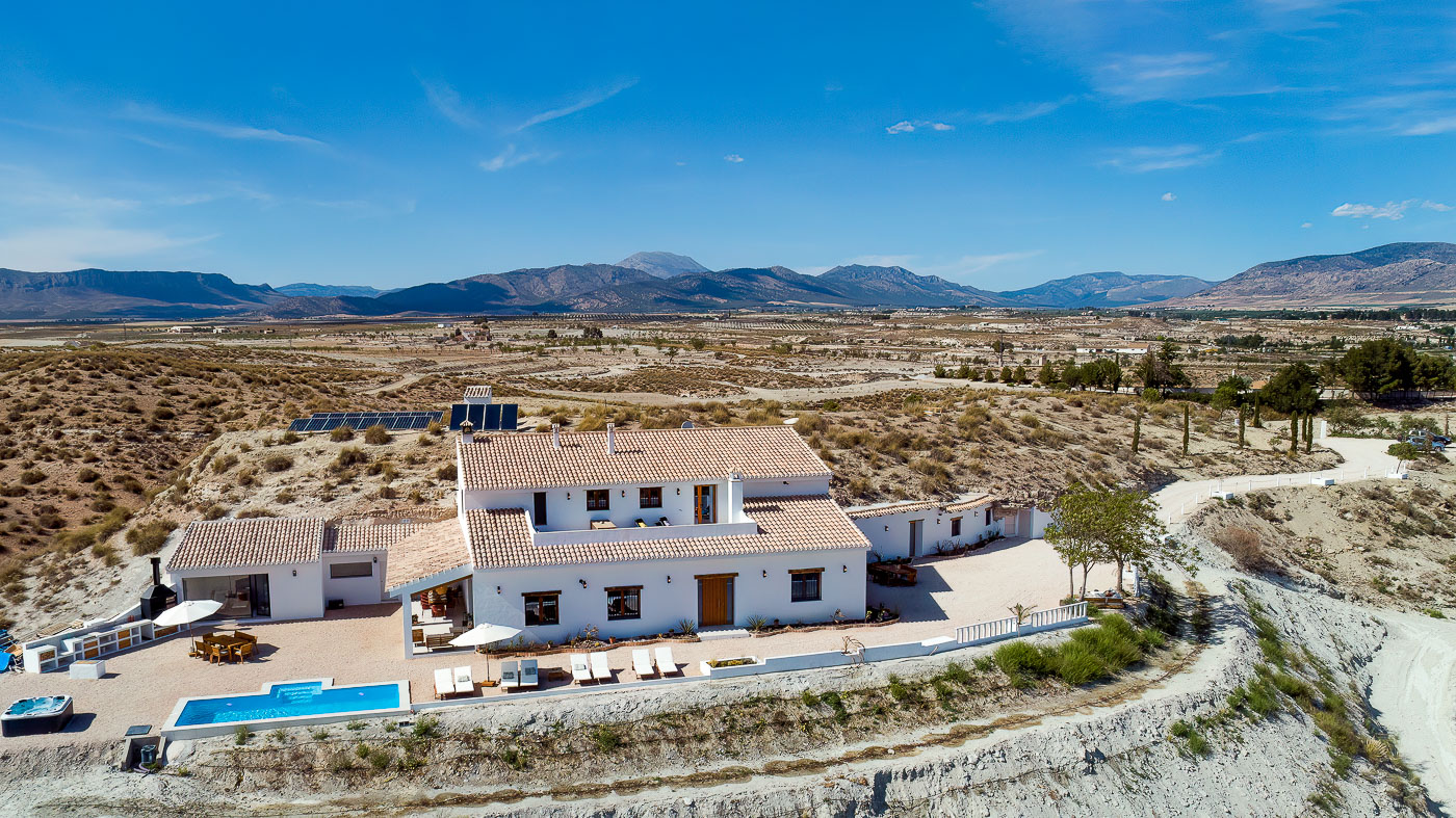 Badlands surrounded by high mountains in the distance